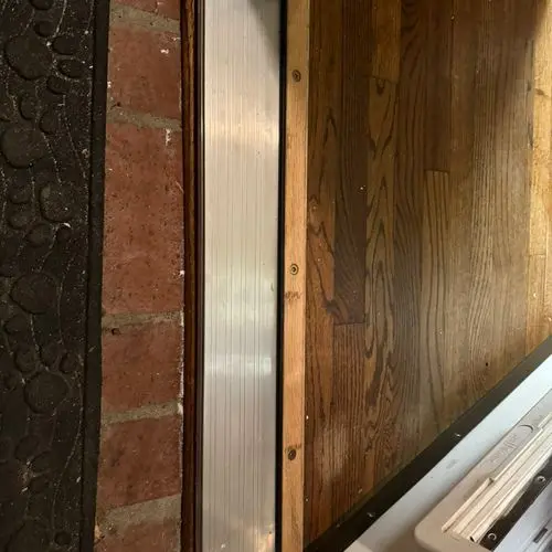 Aluminum threshold strip installed at exterior door sill. Work by Construction Hub in Los Angeles.